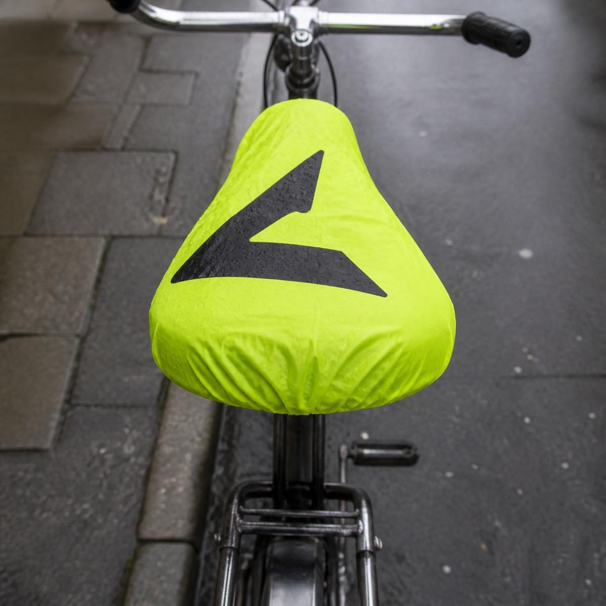 The same saddle wearing a branded neon-yellow waterproof seat cover