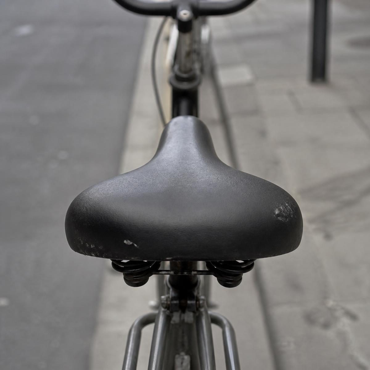 Plain black bicycle saddle with no cover